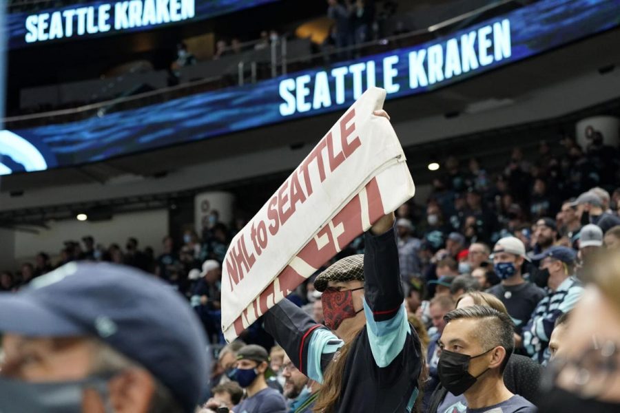 Fans of the Seattle Kraken cheering them on during their first home game against the Vancouver Canucks.