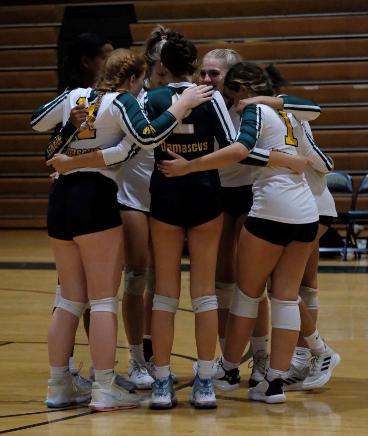 The Varsity volleyball team discusses the last possession during  their match against Blake.