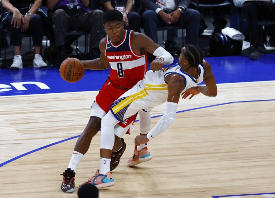 Rui Hachimura from the Wizards attempts to get past Moses Moody from the Golden State Warriors in Japan.