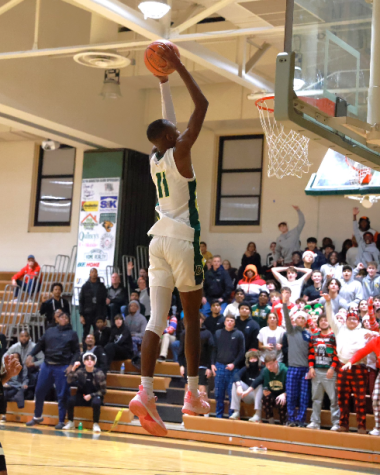 Senior Michael Baskerville ending a fastbreak possession against Kennedy with a dunk.