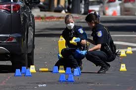 Investigators examine a crime scene at one of three mass shootings in California that occurred within 44 hours.
