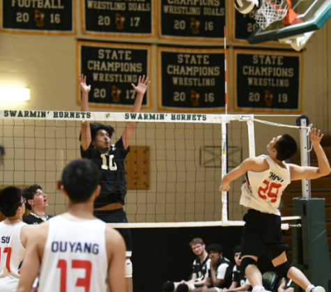 Outside hitter and current sophomore Cesar Aguirre rising up for a block during a match against Wootton High School last spring.