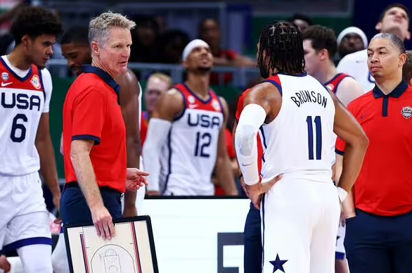 Head Coach Steve Kerr (left), Jalen Brunson, and Assistant Coach Tyronn Lue (right) following an upset loss against Lithuania in this years FIBA World Cup.