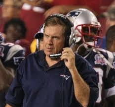 Bill holds his headset thinking of what play he wants to run next as the Patriots play the Redskins in 2009.