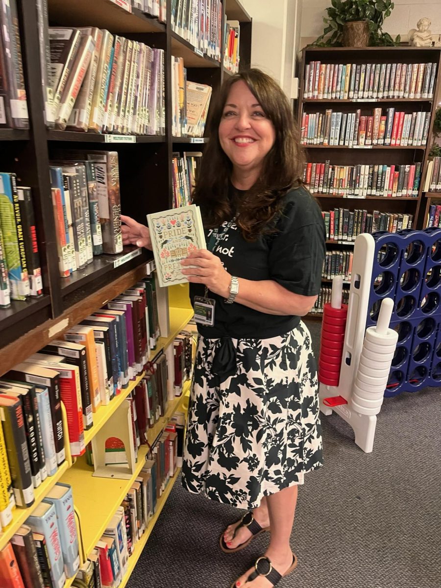 Kimberly Grossett shows off one of the Media Center's many books available to DHS students and staff members. 