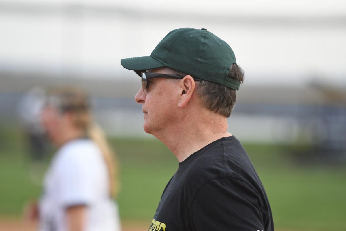 Coach Warfield instructing baserunners on their next move at Urbana.